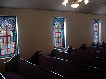 Stained glass church window coverings in a church setting